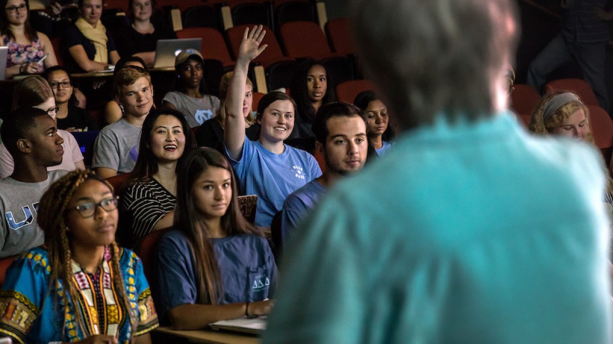 A student raises her hand in class.